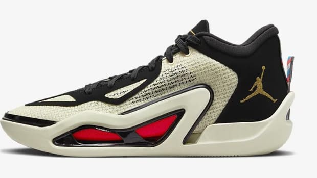 Side view of white, black, and red Jordan Tatum 1 sneakers.